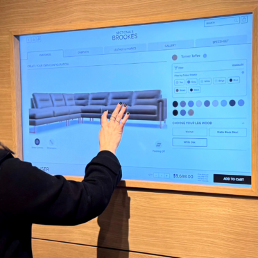 Woman using a 3D product configurator for furniture on a touchscreen